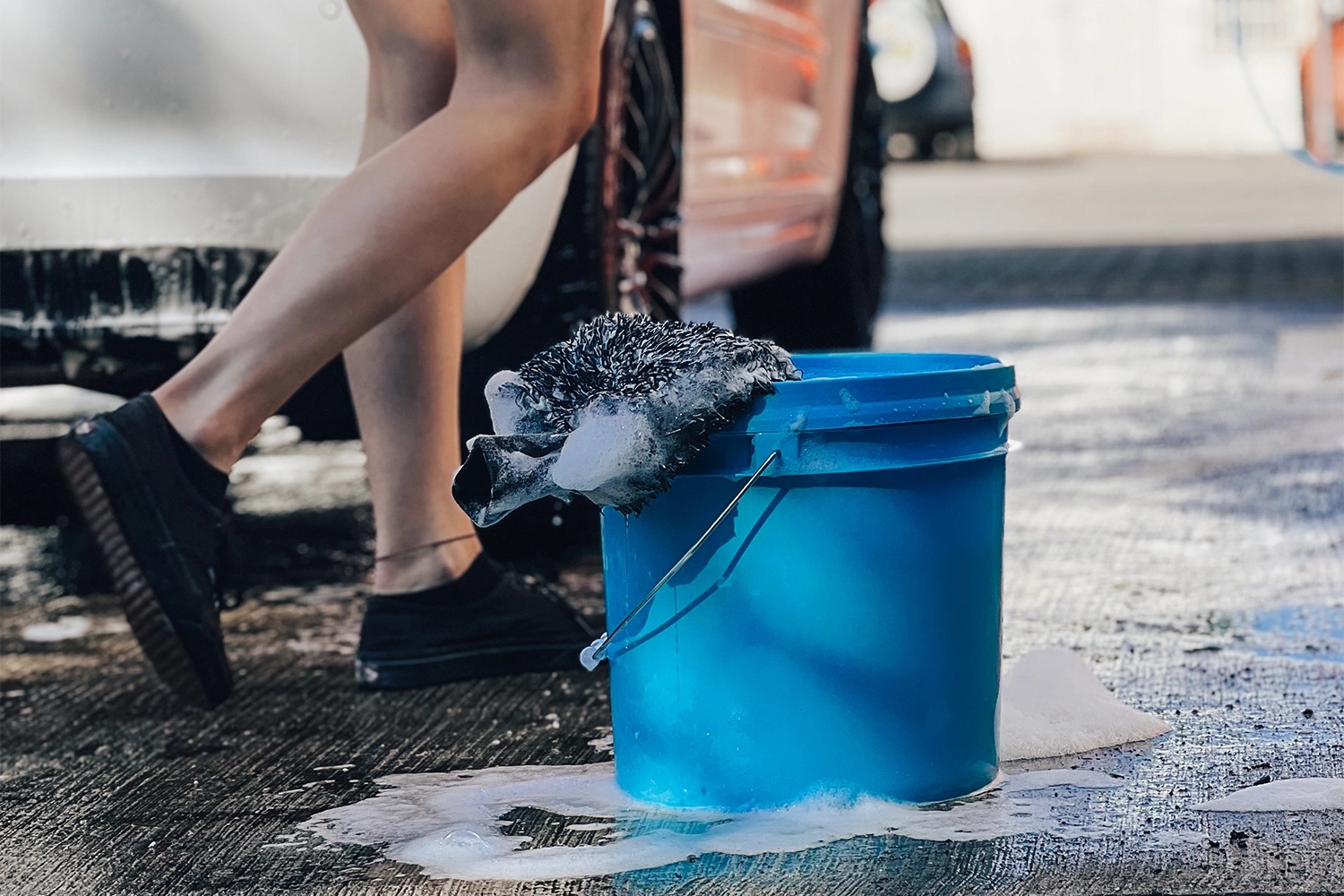 Zwei-Eimer-Methode beim Auto waschen: Eimer mit Shampoolösung und Eimer mit klarem Spülwasser samt Waschhandschuh